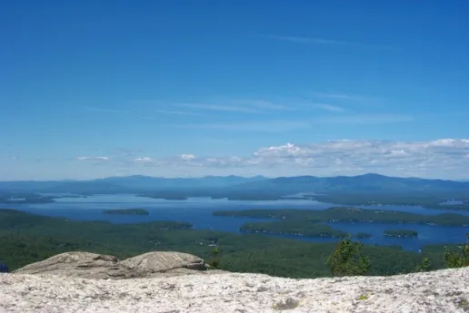 Image shows the top of Mount Major with a view of Lake Winnipesaukee. 